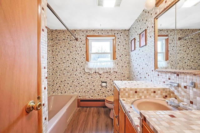 full bath featuring visible vents, toilet, wood finished floors, tile walls, and baseboard heating