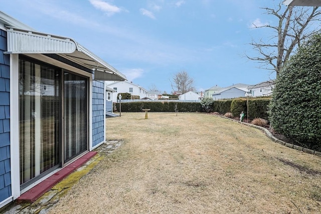 view of yard with a residential view and fence