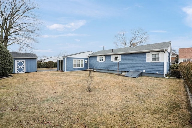 back of property featuring a yard, a storage shed, and an outdoor structure