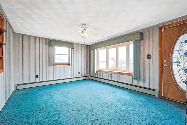 carpeted empty room featuring a ceiling fan