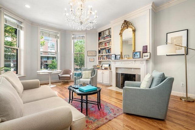 341 Beacon Unit 2F, Boston, MA 02116 - living room featuring a chandelier, ornamental molding, light wood-type flooring, a fireplace with flush hearth, and built in shelves
