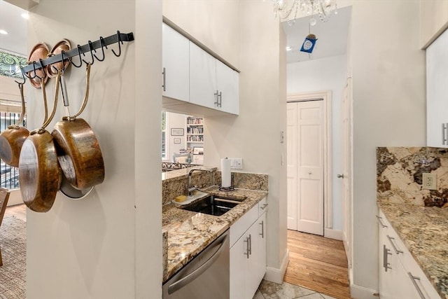 341 Beacon Unit 2F, Boston, MA 02116 - kitchen with dishwasher, white cabinetry, light stone countertops, and light wood-style flooring