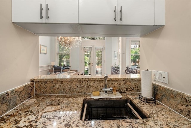 341 Beacon Unit 2F, Boston, MA 02116 - kitchen featuring a chandelier, white cabinets, and stone countertops
