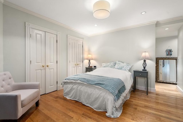 341 Beacon Unit 2F, Boston, MA 02116 - bedroom with crown molding, wood finished floors, two closets, and recessed lighting