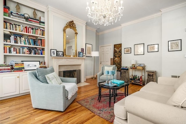 341 Beacon Unit 2F, Boston, MA 02116 - living room with crown molding, a chandelier, light wood finished floors, and a fireplace with flush hearth