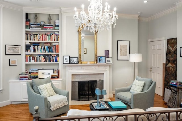 341 Beacon Unit 2F, Boston, MA 02116 - living area with wood finished floors, a high end fireplace, crown molding, a chandelier, and built in features