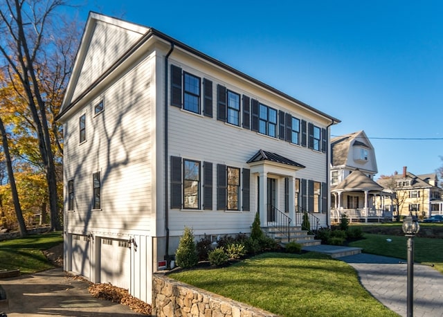 view of front of house featuring a front lawn and a garage