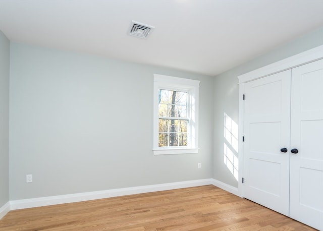 spare room featuring light wood-type flooring