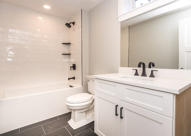 full bathroom featuring tile patterned flooring, vanity, tiled shower / bath combo, and toilet