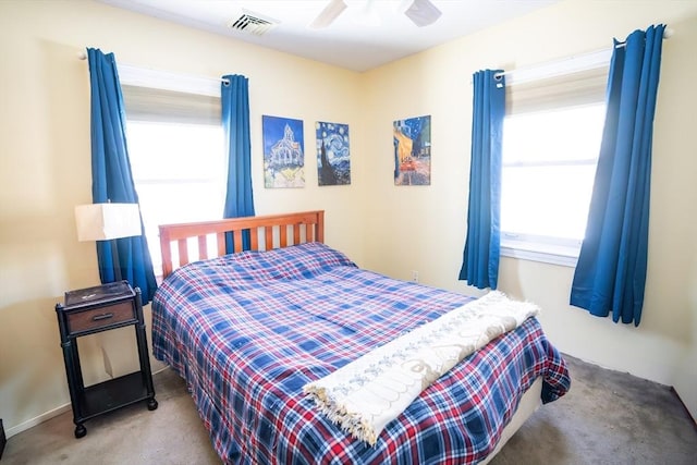 bedroom with multiple windows, carpet flooring, and ceiling fan