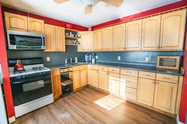 kitchen featuring light brown cabinets, ceiling fan, sink, hardwood / wood-style flooring, and range with gas stovetop