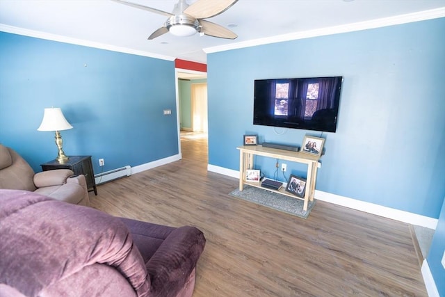 living room with ceiling fan, wood-type flooring, a baseboard heating unit, and crown molding