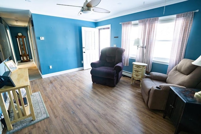 living room featuring ceiling fan, hardwood / wood-style floors, a baseboard radiator, and crown molding