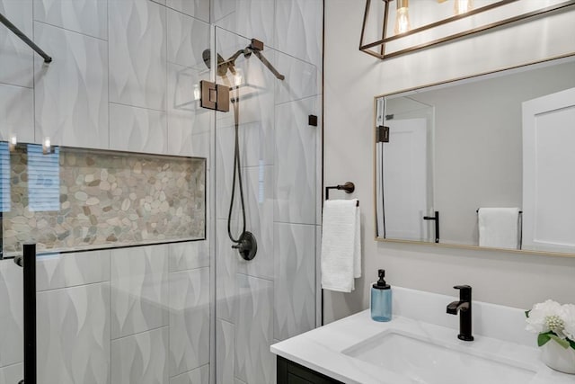 bathroom featuring vanity and a shower with shower door