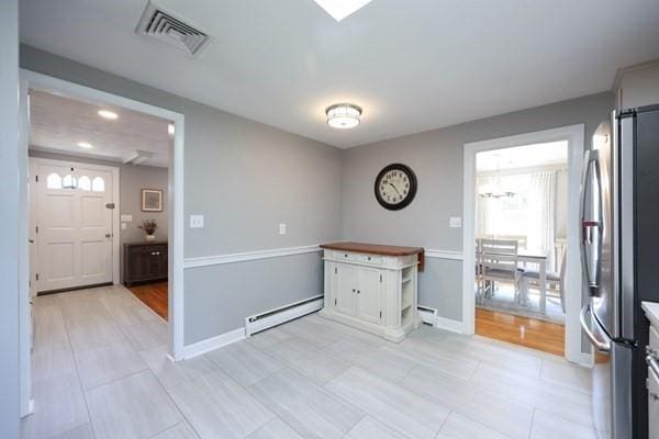 61 Colwell, Dedham, MA 02026 - spare room with baseboard heating, plenty of natural light, recessed lighting, and light tile patterned floors