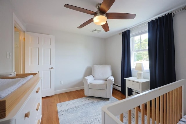 61 Colwell, Dedham, MA 02026 - bedroom with a baseboard heating unit, light wood-type flooring, and a ceiling fan