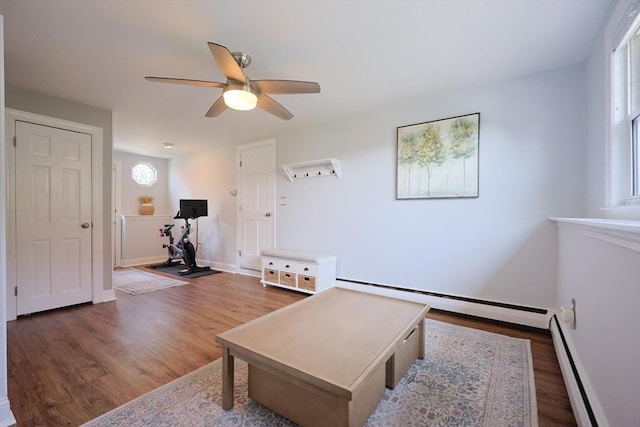 61 Colwell, Dedham, MA 02026 - living area featuring a baseboard heating unit, a baseboard radiator, wood finished floors, and a ceiling fan