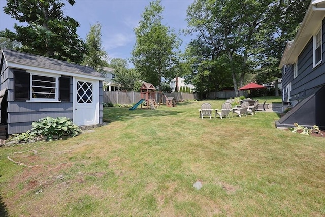 61 Colwell, Dedham, MA 02026 - fenced backyard featuring a playground and a storage unit