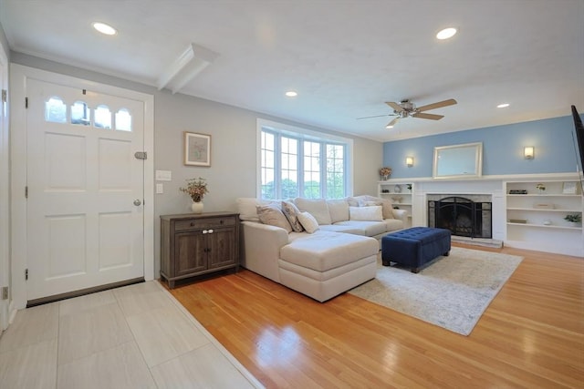 61 Colwell, Dedham, MA 02026 - living area featuring a ceiling fan, recessed lighting, a fireplace with raised hearth, and light wood-style floors