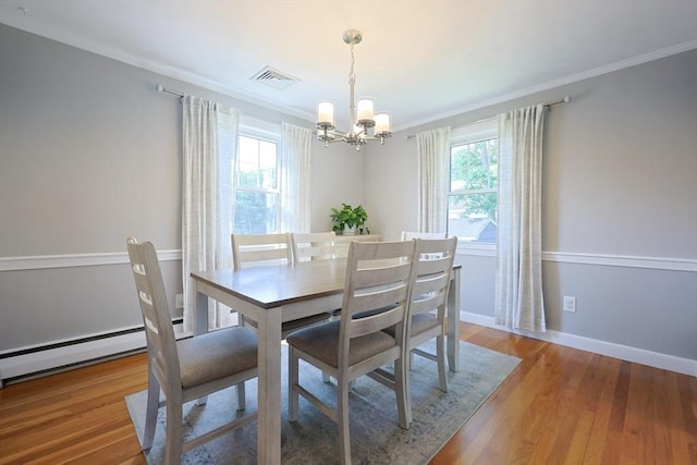 61 Colwell, Dedham, MA 02026 - dining space with a chandelier, healthy amount of natural light, crown molding, wood finished floors, and a baseboard heating unit