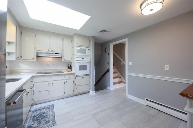 61 Colwell, Dedham, MA 02026 - kitchen featuring white appliances, a baseboard heating unit, under cabinet range hood, backsplash, and light countertops