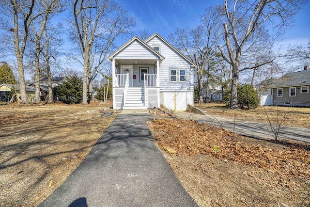 view of front of property with aphalt driveway and a porch