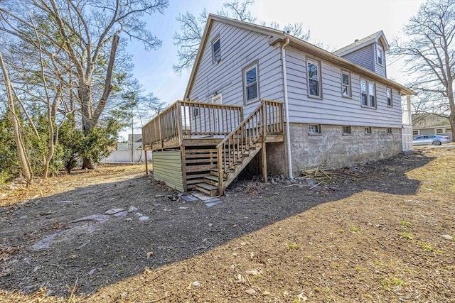 view of home's exterior with stairs and a wooden deck