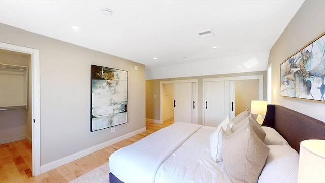 bedroom featuring light wood-style flooring, recessed lighting, and baseboards
