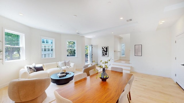 living area featuring light wood-style flooring, recessed lighting, and baseboards