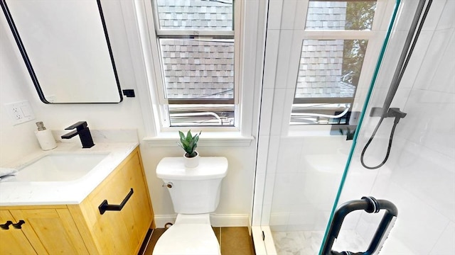 full bath with a stall shower, toilet, and vanity