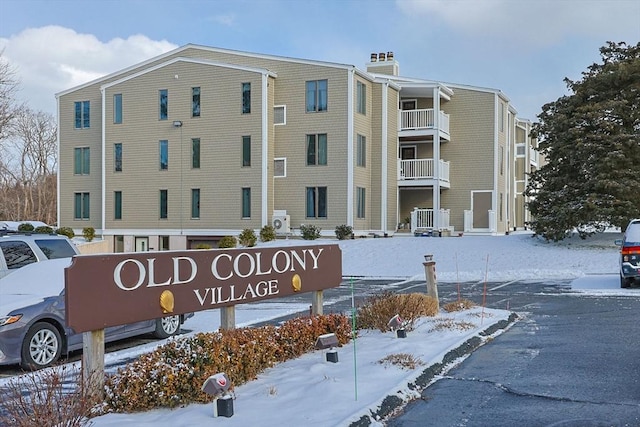 snow covered property featuring ac unit