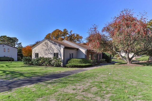 view of property exterior featuring a lawn