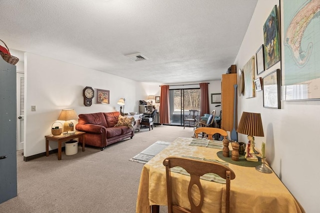 living room with a textured ceiling and light carpet