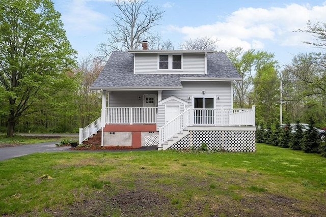 129 S Main St, Raynham, MA 02767 - view of front of home with covered porch, a front yard, a chimney, roof with shingles, and stairs