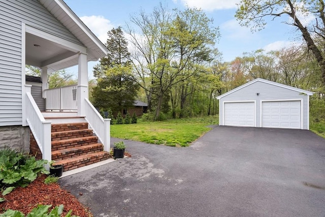 129 S Main St, Raynham, MA 02767 - view of green lawn with an outbuilding, a detached garage, and a porch