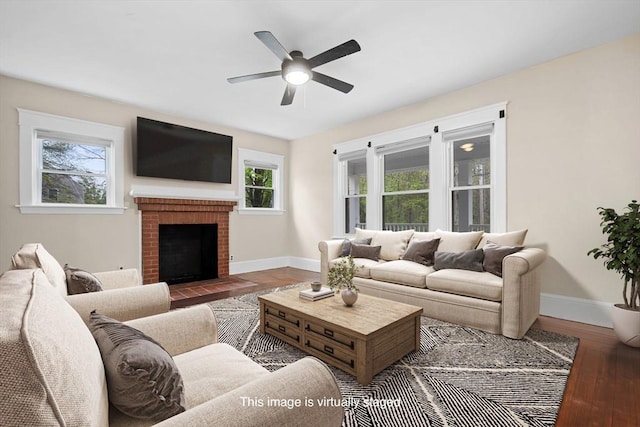 129 S Main St, Raynham, MA 02767 - living room featuring baseboards, a ceiling fan, wood finished floors, and a fireplace