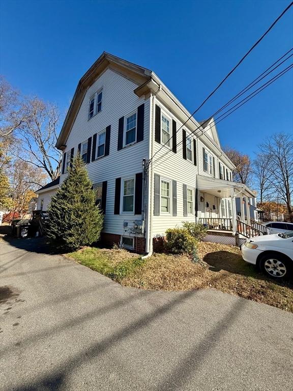 view of side of property with covered porch