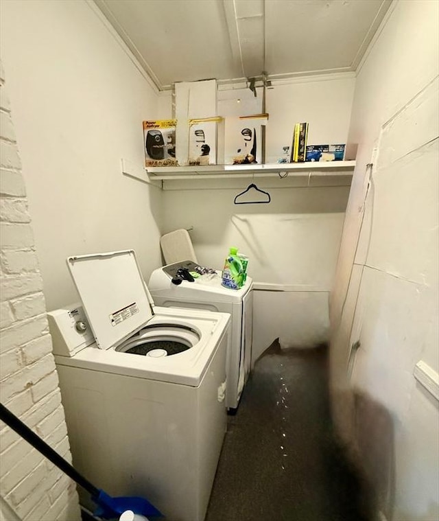 laundry area with washing machine and dryer and ornamental molding