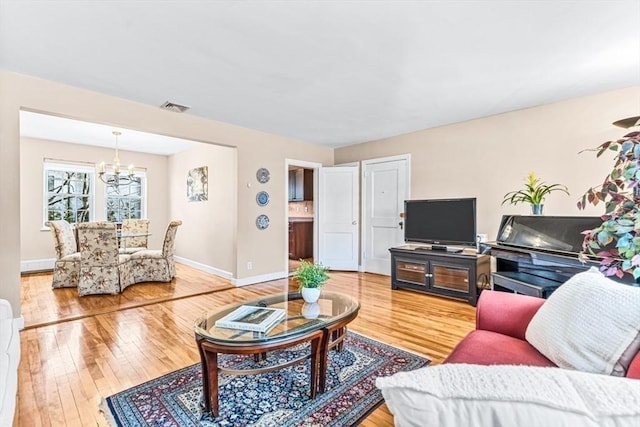 living room featuring hardwood / wood-style floors and a chandelier