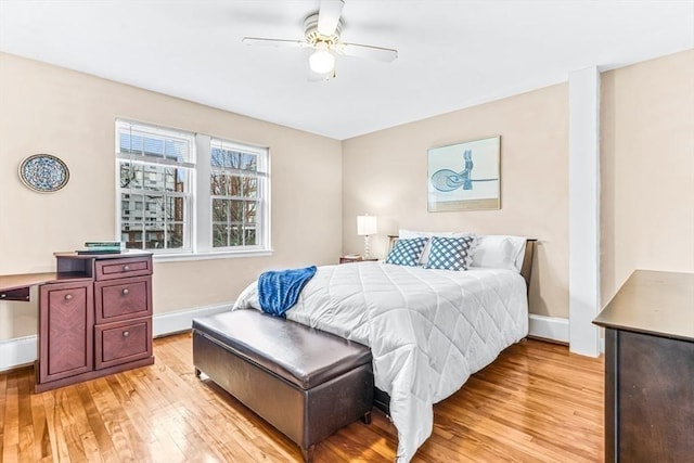 bedroom with light hardwood / wood-style flooring and ceiling fan