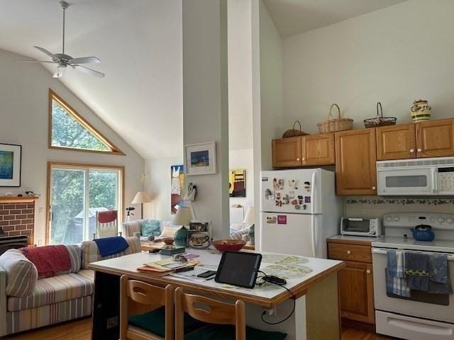 190 Longview Rd, West Tisbury, MA 02575 - kitchen with white appliances, open floor plan, light countertops, vaulted ceiling, and light wood-style floors
