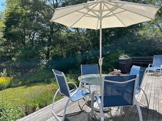 190 Longview Rd, West Tisbury, MA 02575 - deck with outdoor dining area and view of wooded area