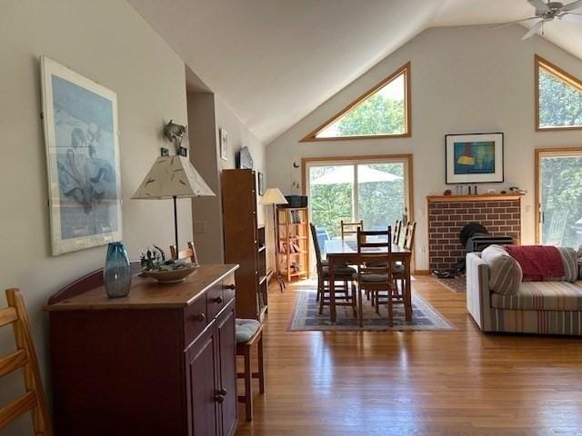 190 Longview Rd, West Tisbury, MA 02575 - dining room with plenty of natural light, wood finished floors, a ceiling fan, a brick fireplace, and high vaulted ceiling