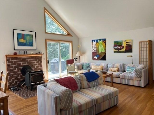 190 Longview Rd, West Tisbury, MA 02575 - living area with a wood stove, wood finished floors, and high vaulted ceiling