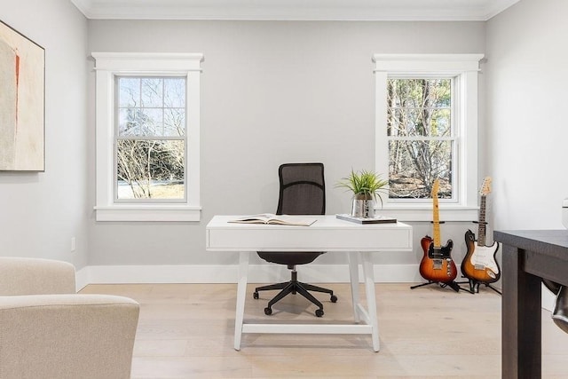 home office featuring crown molding, baseboards, and wood finished floors