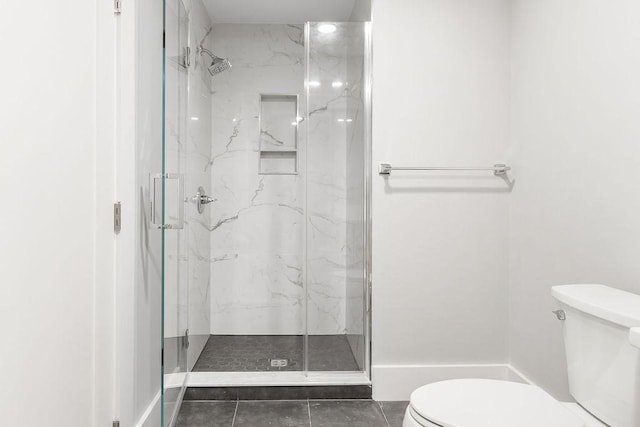 full bath featuring tile patterned flooring, a marble finish shower, and toilet