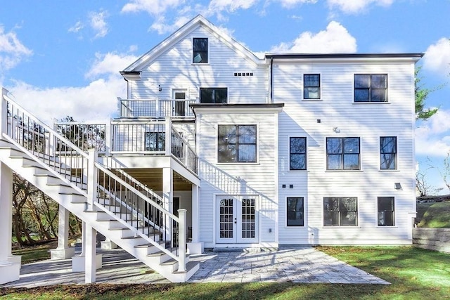 back of property with stairs, a patio, and french doors