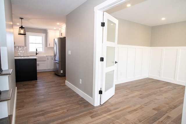 corridor with sink and hardwood / wood-style flooring