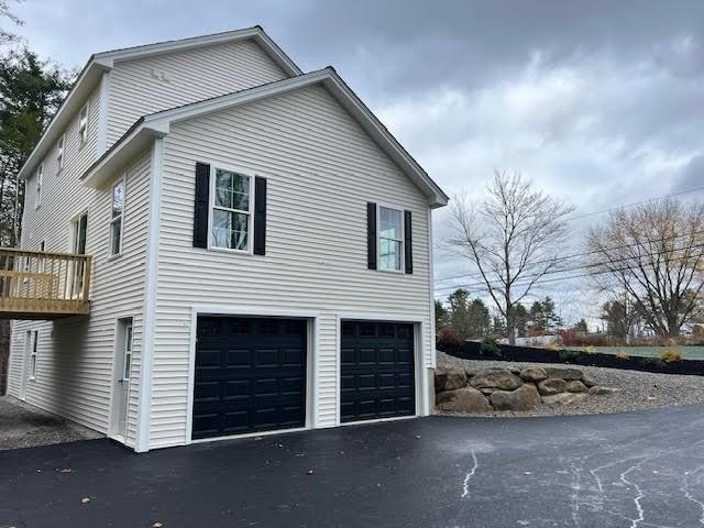 view of side of property featuring a garage