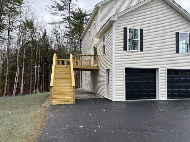 view of home's exterior featuring a deck and a garage